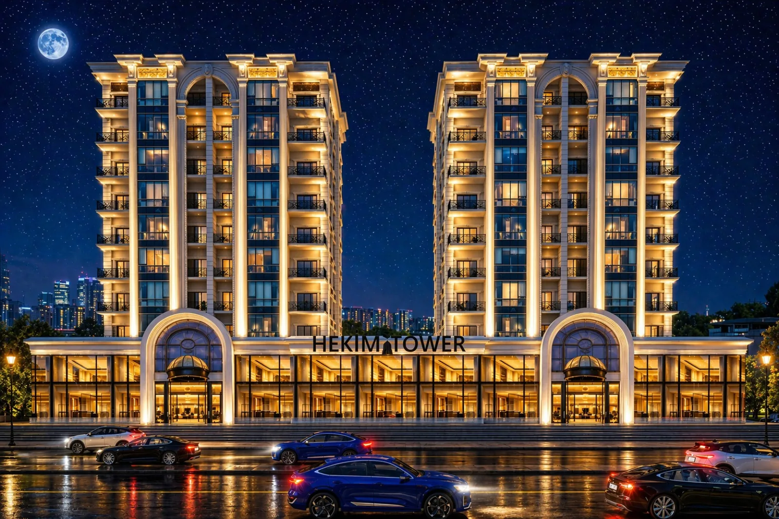 Gece bulvar cephesi: aydınlatılmış iki blok, kemerli girişler ve önündeki araç trafiği