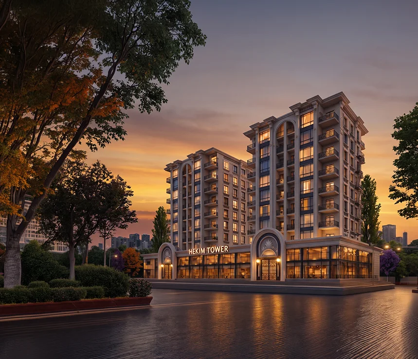 Hekim Tower'ın iki bloğu gün batımında: kemerli ana giriş, ışıklı zemin kat vitrinleri ve cephedeki Hekim Tower tabelası