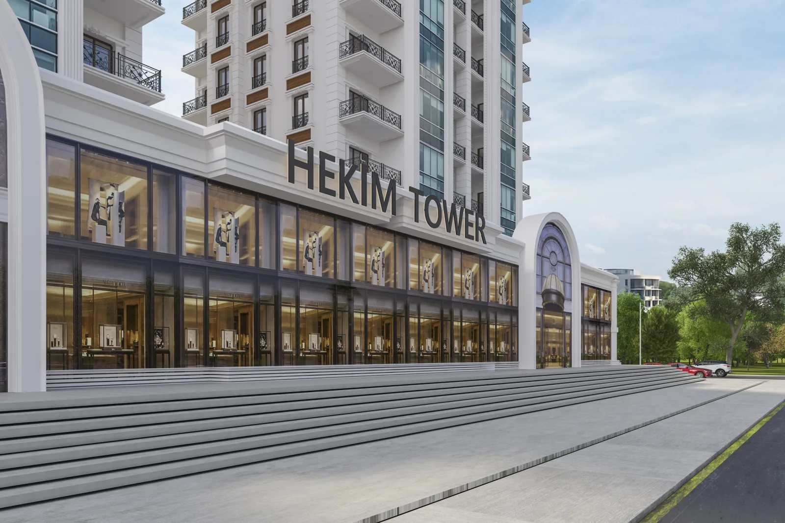 Sokak cephesinden Hekim Tower tabelası, vitrinli dükkanlar ve geniş yaya merdiveni
